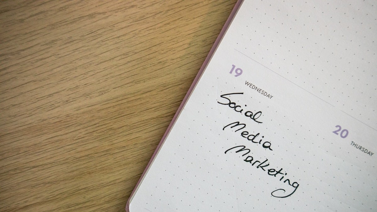 Desk with a planner with the words Social Media Marketing on it